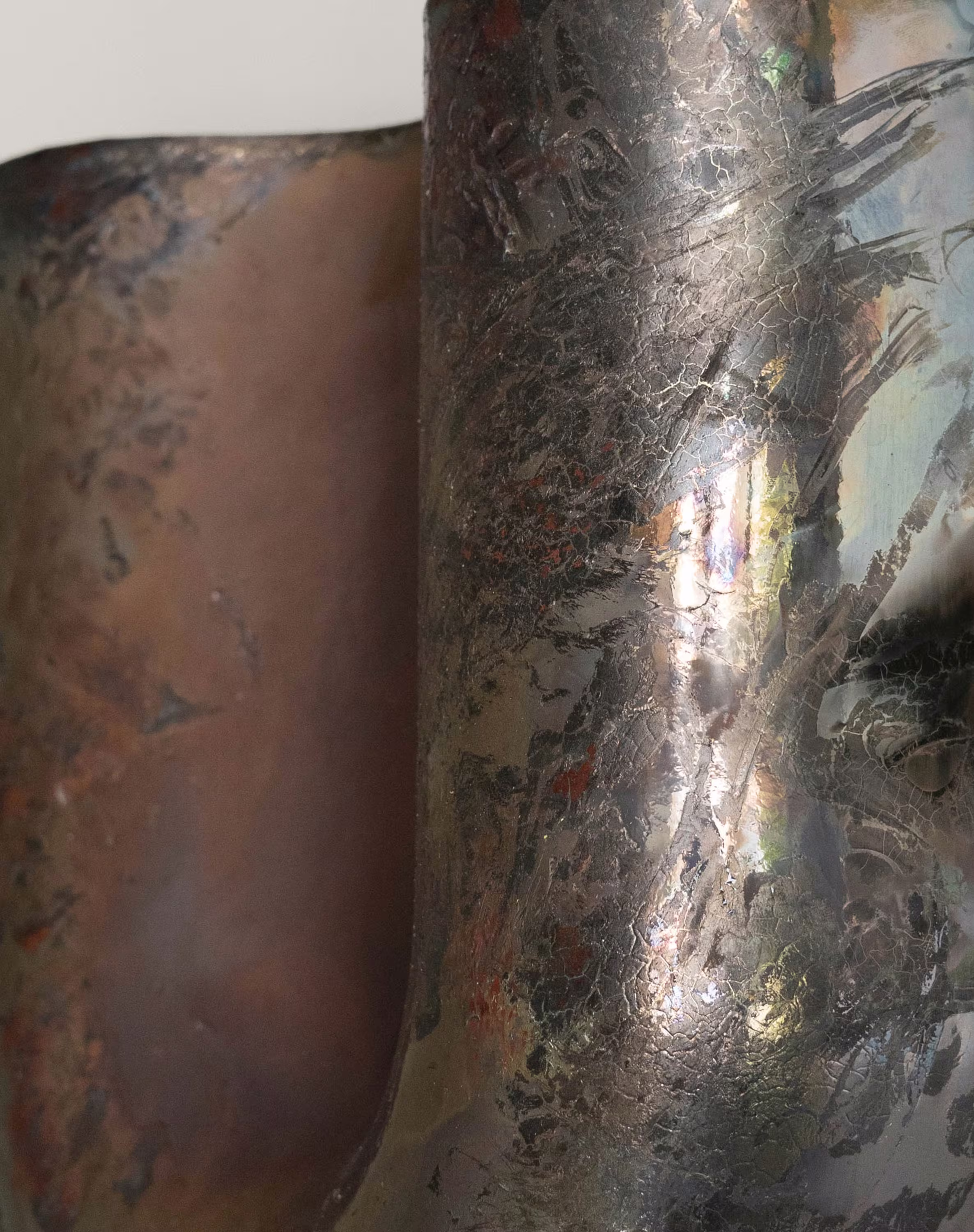 Copper sconce with textured raku finish, displaying an iridescent, earthy patina.